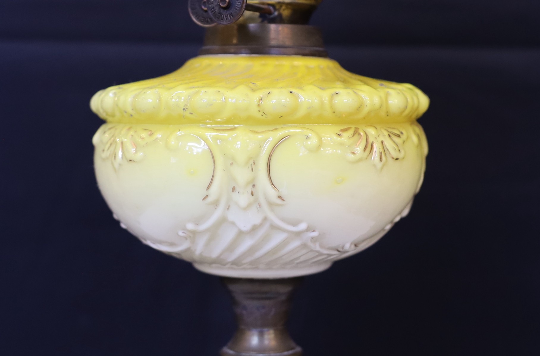 A Victorian brass oil lamp with opaque yellow glass reservoir, duplex mechanism, etched glass globe and flue, height overall 72cm